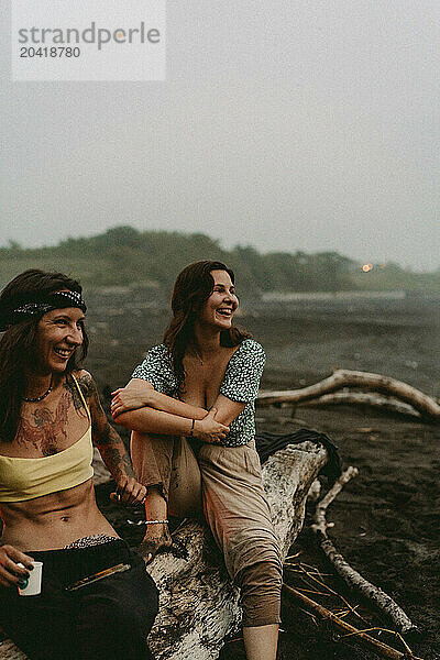 Friends having a picnic on the beach near the ocean.