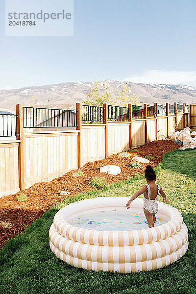 Toddler Girl in Backyard Pool