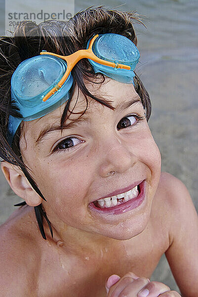 happy boy on beach with goggles