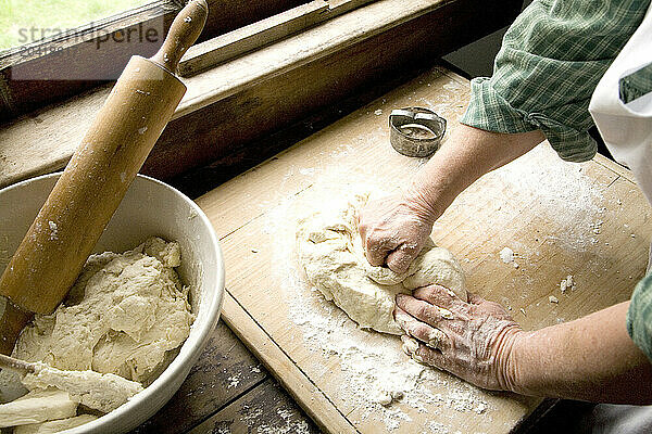 Woman making biscuits  kneading the dough.