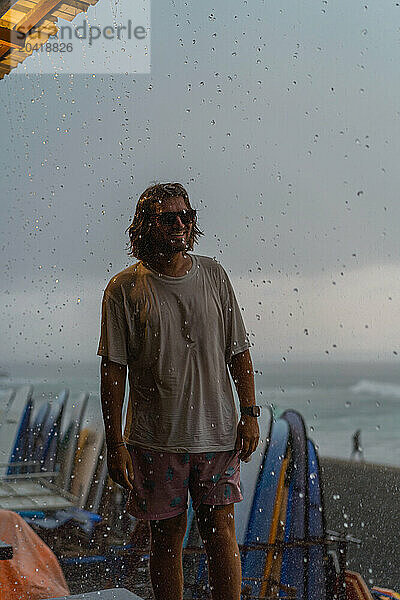 Young man walks in the rain.