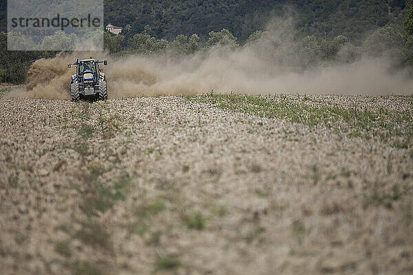 Working the fields with the tractor.