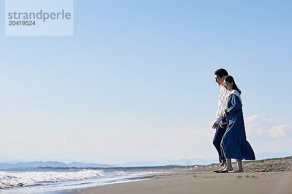 Japanese couple standing on the beach