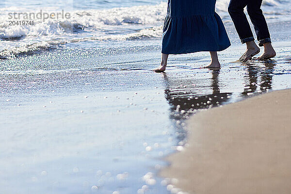 Japanese couple walking on the beach