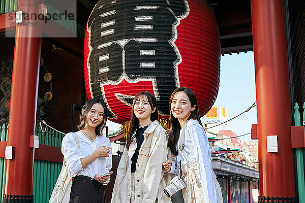 Japanese friends visiting traditional temple in Tokyo