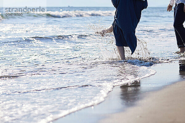 Japanese couple walking on the beach