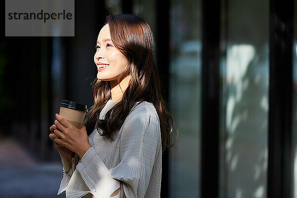 Japanese woman holding a coffee cup