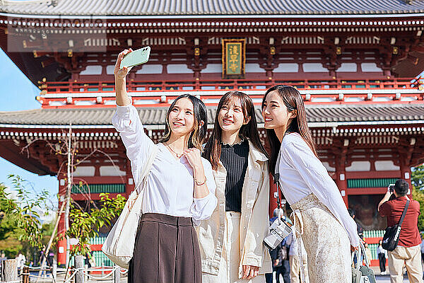 Japanese friends visiting traditional temple in Tokyo