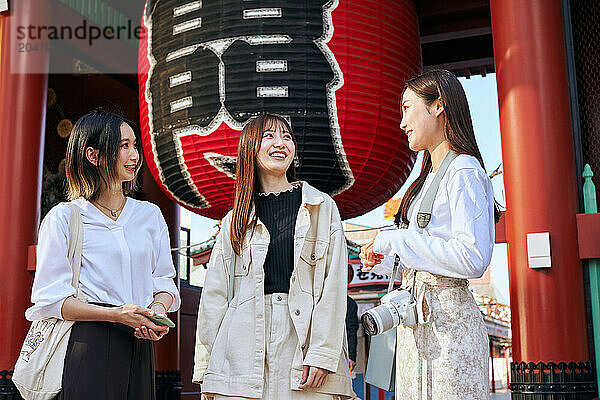 Japanese friends visiting traditional temple in Tokyo