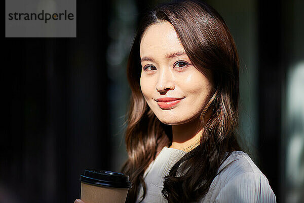 Japanese woman holding a coffee cup