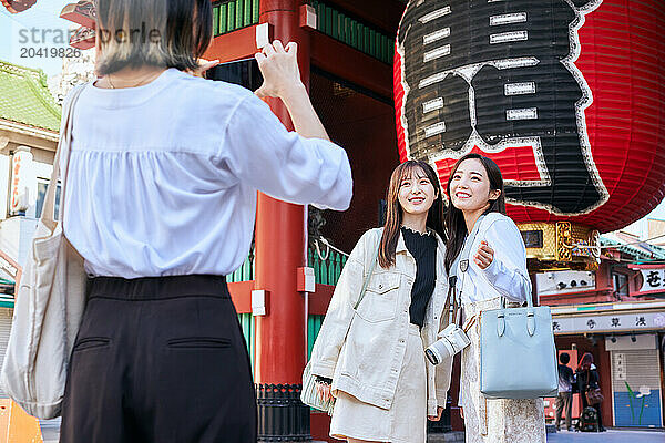 Japanese friends visiting traditional temple in Tokyo