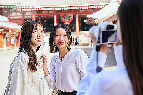 Japanese friends visiting traditional temple in Tokyo