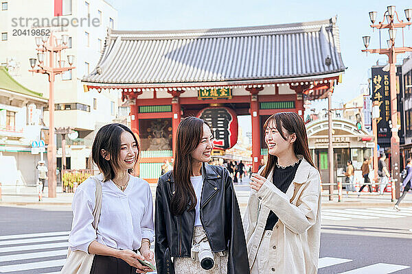 Japanese friends visiting traditional temple in Tokyo