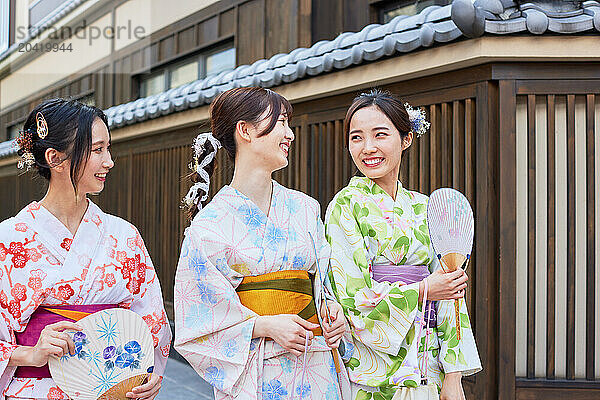 Japanese friends wearing yukata visiting traditional area in Tokyo