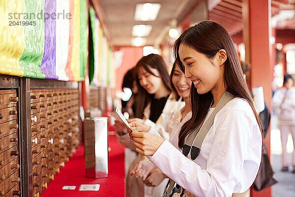 Japanese friends visiting traditional temple in Tokyo