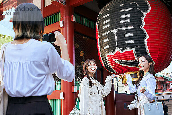 Japanese friends visiting traditional temple in Tokyo