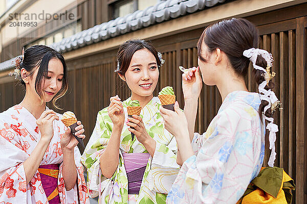 Japanese friends wearing yukata visiting traditional area in Tokyo