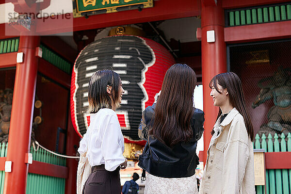 Japanese friends visiting traditional temple in Tokyo