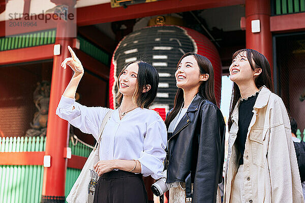 Japanese friends visiting traditional temple in Tokyo