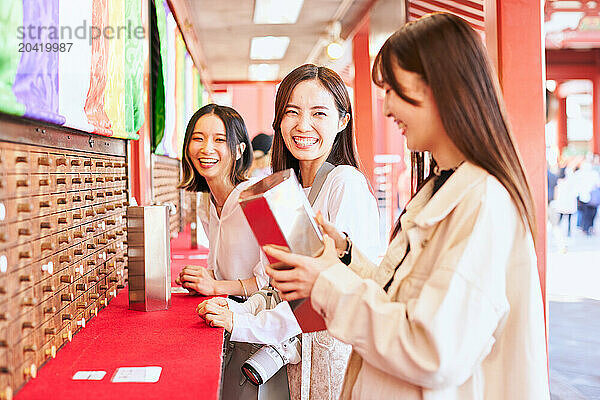 Japanese friends visiting traditional temple in Tokyo