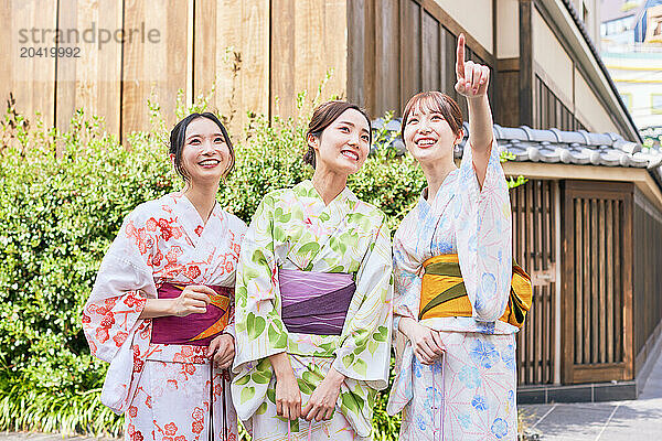 Japanese friends wearing yukata visiting traditional area in Tokyo