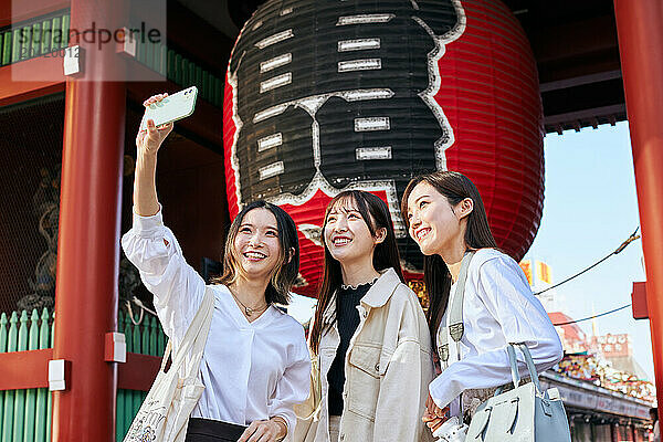 Japanese friends visiting traditional temple in Tokyo