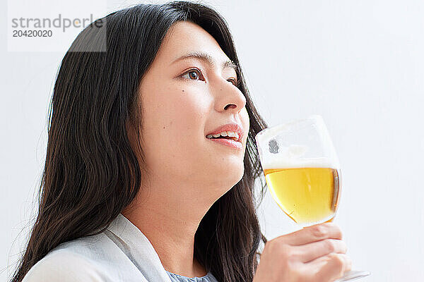 Japanese woman holding a glass of beer