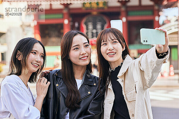 Japanese friends visiting traditional temple in Tokyo