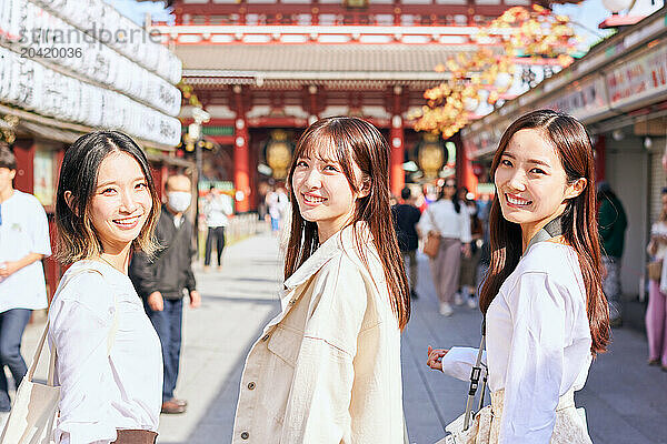 Japanese friends visiting traditional temple in Tokyo