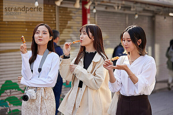 Japanese friends visiting traditional temple in Tokyo