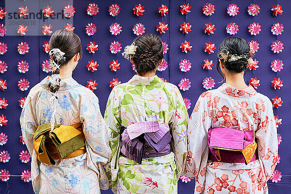 Japanese friends wearing yukata visiting traditional area in Tokyo