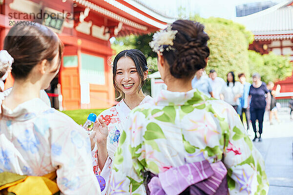 Japanese friends wearing yukata visiting traditional area in Tokyo