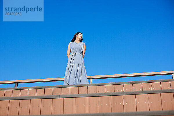 Japanese woman against blue sky