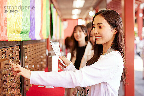 Japanese friends visiting traditional temple in Tokyo