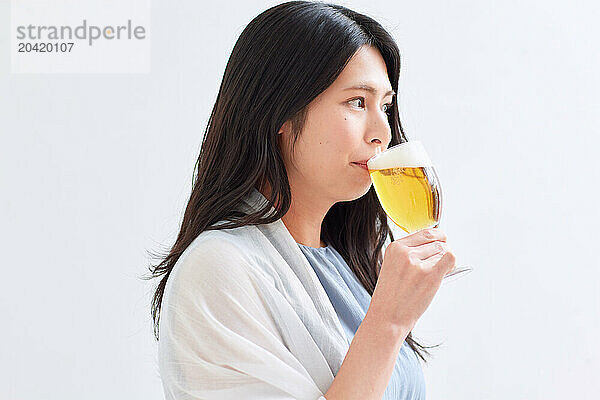 Japanese woman holding a glass of beer