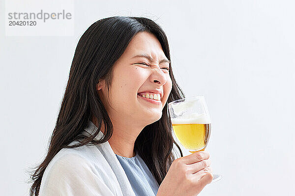 Japanese woman holding a glass of beer