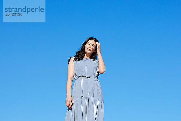 Japanese woman against blue sky