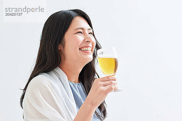 Japanese woman holding a glass of beer