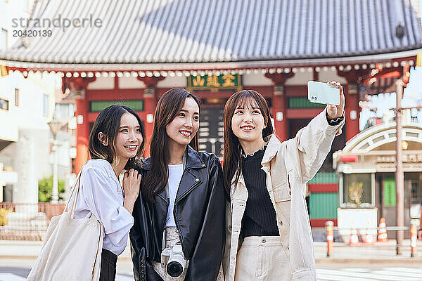 Japanese friends visiting traditional temple in Tokyo