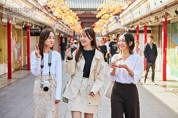 Japanese friends visiting traditional temple in Tokyo