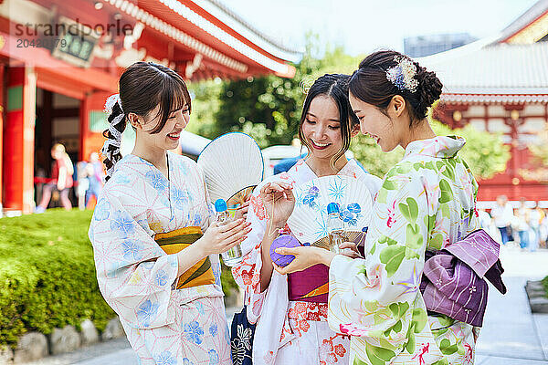 Japanese friends wearing yukata visiting traditional area in Tokyo