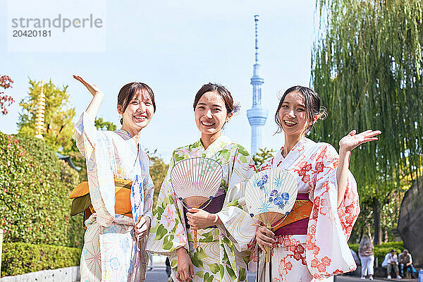 Japanese friends wearing yukata visiting traditional area in Tokyo