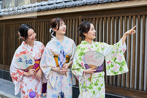 Japanese friends wearing yukata visiting traditional area in Tokyo