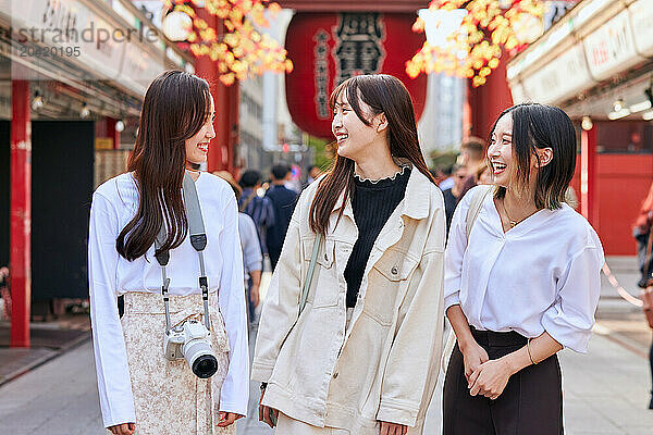 Japanese friends visiting traditional temple in Tokyo