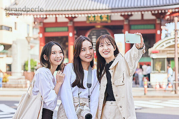 Japanese friends visiting traditional temple in Tokyo