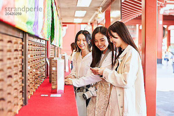 Japanese friends visiting traditional temple in Tokyo