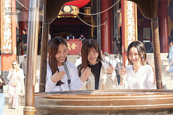 Japanese friends visiting traditional temple in Tokyo