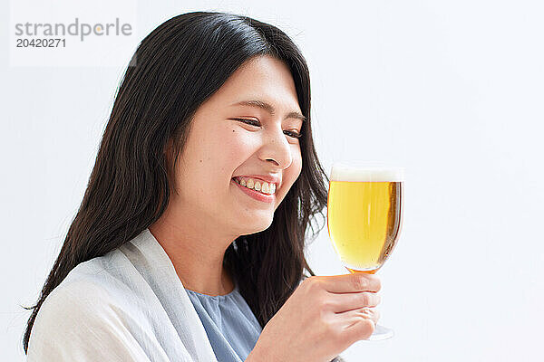 Japanese woman holding a glass of beer