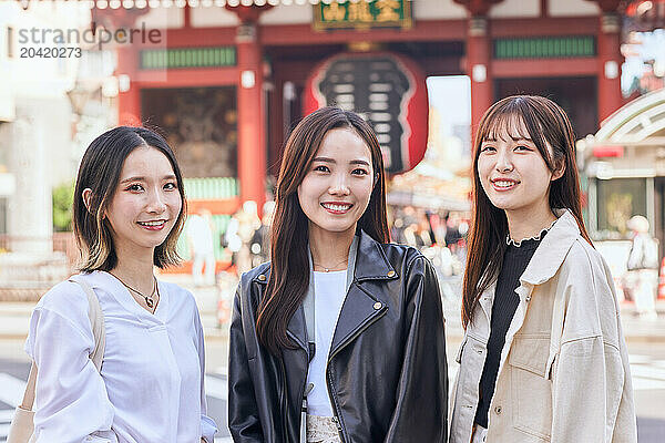 Japanese friends visiting traditional temple in Tokyo