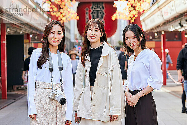 Japanese friends visiting traditional temple in Tokyo